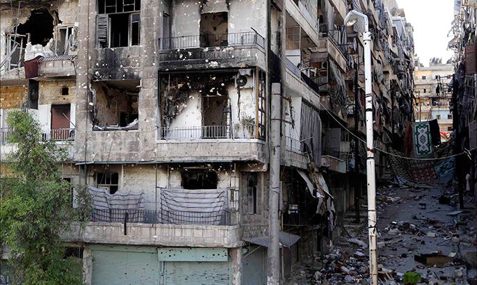 Curtains are erected in a building to provide protection from snipers loyal to Syria's President Bashar al-Assad on a damaged street full of debris in Sheikh Maksoud area in Aleppo July 9, 2013. REUTERS/Muzaffar Salman (SYRIA - Tags: CONFLICT CIVIL UNREST POLITICS)