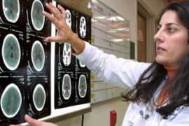 A doctor looks over a CT scan of a brain near the emergency room at the Childrens National Medical Center in Washington in this 20 file photo. Millions of Americans, especially children, are needlessly getting dangerous radiation from "super X-rays" that raise the risk of cancer and are increasingly used to diagnose medical problems, a new report warns.