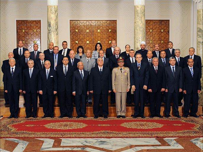 In this hand out picture released by the Egyptian presidency Egypt's interim president Adly Mansour(C) and the newly sworn in Egypt's interim cabinet pose for a group picture on July 16, 2013 in Cairo. Egypt's first government since the military ousted Islamist president Mohamed Morsi almost two weeks ago was officially sworn in state television reported. The 35-member cabinet, including caretaker prime minister Hazem al-Beblawi, individually took their oath before army-appointed interim president Adly Mansour. AFP PHOTO/HO/EGYPTIAN PRESIDENCY == RESTRICTED TO EDITORIAL USE - MANDATORY CREDIT "AFP PHOTO / EGYPTIAN PRESIDENCY" - NO MARKETING NO ADVERTISING CAMPAIGNS - DISTRIBUTED AS A SERVICE TO CLIENTS ==