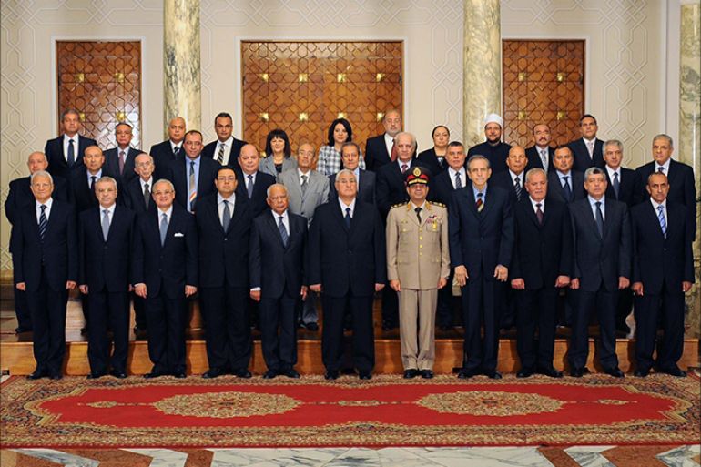 In this hand out picture released by the Egyptian presidency Egypt's interim president Adly Mansour(C) and the newly sworn in Egypt's interim cabinet pose for a group picture on July 16, 2013 in Cairo. Egypt's first government since the military ousted Islamist president Mohamed Morsi almost two weeks ago was officially sworn in state television reported. The 35-member cabinet, including caretaker prime minister Hazem al-Beblawi, individually took their oath before army-appointed interim president Adly Mansour. AFP PHOTO/HO/EGYPTIAN PRESIDENCY == RESTRICTED TO EDITORIAL USE - MANDATORY CREDIT "AFP PHOTO / EGYPTIAN PRESIDENCY" - NO MARKETING NO ADVERTISING CAMPAIGNS - DISTRIBUTED AS A SERVICE TO CLIENTS ==