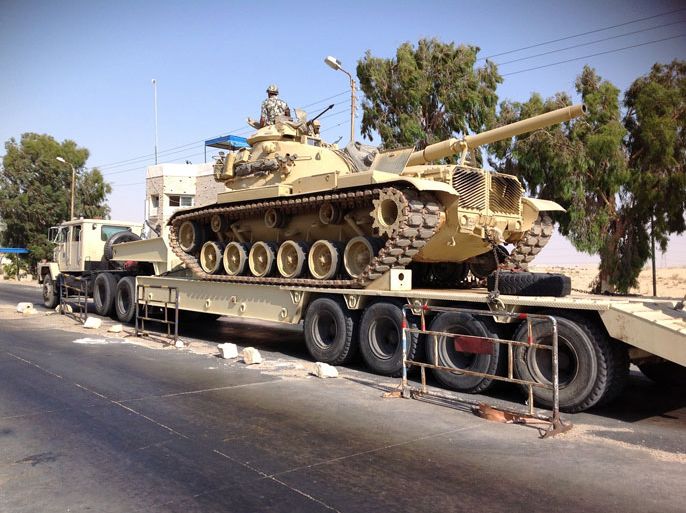 ARI800 - Al-ARISH, -, EGYPT : An Egyptian military tank is deployed in the northern Sinai town of Al-Arish on July 16, 2013. With an insurgency threatening its sensitive border with Israel, Egypt's military is preparing to go on the offensive against Sinai militants who have escalated attacks since president Mohamed Morsi's ouster. AFP PHOTO / STR