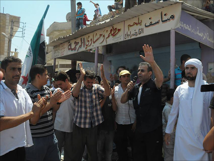 الشاعر نوري الجراح يلقي كلمة في مظاهرة داخل سوريا(الجزيرة)