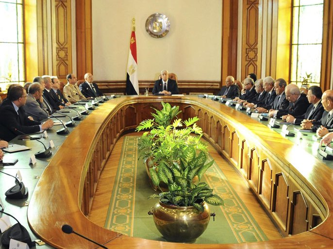 Egypt's interim President Adli Mansour (C) attends the first meeting with new government ministers at El-Thadiya presidential palace in Cairo in this handout picture dated July 16, 2013. Egypt's interim government sets about the mammoth task of returning the country to civilian rule and rescuing the economy on Wednesday, a process complicated by deadly protests and a political stalemate with powerful Islamist groups. Interim head of state Mansour, the burly judge leading the army-backed administration, swore in 33 mainly liberal and technocratic ministers at the presidential palace on Tuesday. Picture taken July 16, 2013. REUTERS/Egyptian Presidency/Handout (EGYPT - Tags: POLITICS MILITARY) ATTENTION EDITORS - NO SALES. NO ARCHIVES. THIS IMAGE WAS PROVIDED BY A THIRD PARTY. FOR EDITORIAL USE ONLY. NOT FOR SALE FOR MARKETING OR ADVERTISING CAMPAIGNS. THIS PICTURE IS DISTRIBUTED EXACTLY AS RECEIVED BY REUTERS, AS A SERVICE TO CLIENTS