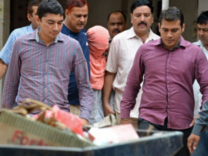 Indian policemen escort the juvenile (C, in pink hood), accused in the December 2012 gang-rape of a student, following his guilty verdict at a court in New Delhi on August 31, 2013.