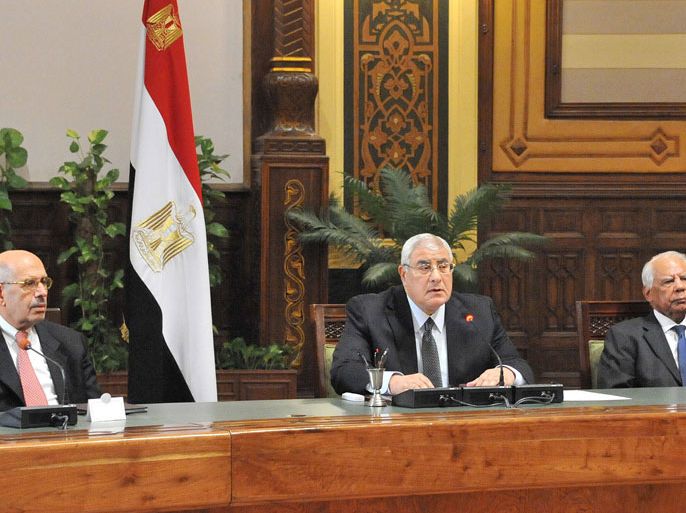 Cairo, -, EGYPT : A handout picture released by the Egyptian Presidency shows Egypt's vice president Mohamed El Baradei (L), interim president Adly Mansour (C) and prime minister Hazem El-Bablawi (R) attending the first meeting of the 20 newly appointed Egyptian Governors on August 13, 2013 in Cairo. The new governors were sworn in by interim President Adly Mansour in a ceremony broadcast on state television. AFP PHOTO/HO/EGYPTIAN PRESIDENCY === RESTRICTED TO EDITORIAL USE - MANDATORY CREDIT "AFP PHOTO / HO /EGYPTIAN PRESIDENCY " - NO MARKETING NO ADVERTISING CAMPAIGNS - DISTRIBUTED AS A SERVICE TO CLIENTS