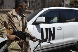 A Free Syrian Army fighter carries his weapon as he and fellow fighters escort a convoy of U.N. vehicles carrying a team of United Nations chemical weapons experts at one of the sites of an alleged chemical weapons attack in Damascus' suburbs of Zamalka August 28, 2013. U.N. chemical weapons experts investigating an apparent gas attack that killed hundreds of civilians in rebel-held suburbs of Damascus made a second trip across the front line to take samples.