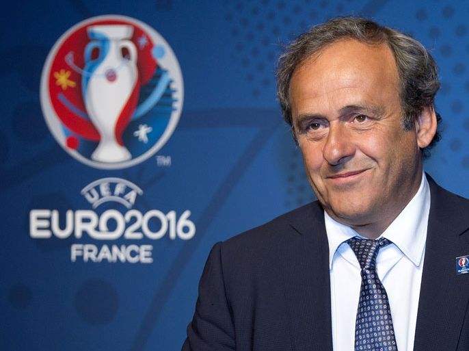 epa03760555 President of UEFA, Michel Platini, poses in front of the logo for the UEFA Euro 2016 to be held in France after the official presentation, in Paris, France, 26 June 2013. EPA/IAN LANGSDON