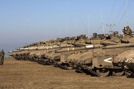 Israeli army Merkava tanks are seen stationed in a deployment training area in the Israeli-annexed Golan Heights near the border with Syria on August 28, 2013. Israel will strike back "fiercely" if Syria attacks the Jewish state, Prime Minister Benjamin Netanyahu said, as the US mulled military action against President Bashar al-Assad's regime. AFP PHOTO/MENAHEM KAHANA