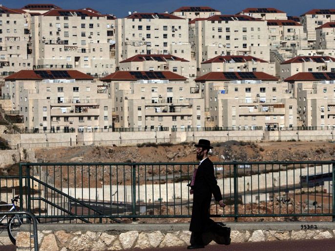 (FILES) -- An Ultra-Orthodox Jewish man walks in the West Bank settlement of Beitar Elit, an ultra-Orthodox bastion south of the biblical Palestinian town of Bethlehem, on December 1, 2009. Israel is inviting bids to build over 1,000 settler homes in the West Bank, including east Jerusalem, the housing ministry said on August 11, 2013, ahead of peace talks with the Palestinians. AFP PHOTO/ MENAHEM KAHANA