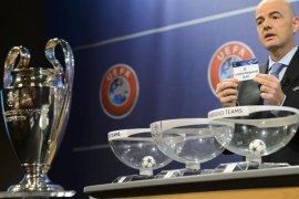 epa03817833 UEFA General Secretary Gianni Infantino shows a ticket with Kazakstan soccer club Shakhter Karagandy during the draw of the play-offs games of UEFA Champions League 2013/14 at the UEFA Headquarters in Nyon, Switzerland, Friday, August 9, 2013. EPA/LAURENT GILLIERON