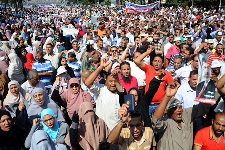 Supporters of the Muslim Brotherhood and Egypt's ousted president Mohamed Morsi chant slogans as they demonstrate in Egypt's northern coastal city of Alexandria on August 14, 2013, against security forces clearing two pro-Morsi protest camps in Cairo. The clearance operation began shortly after dawn when security forces surrounded the sprawling Rabaa al-Adawiya camp in east Cairo and a similar one at Al-Nahda square, in the centre of the capital. AFP PHOTO / STR