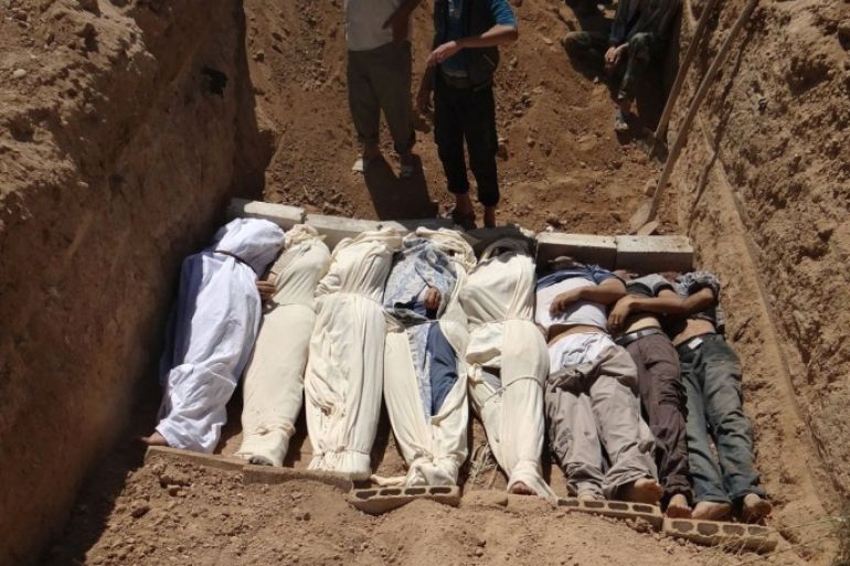 This image provided by by Shaam News Network on Thursday, Aug. 22, 2013, which has been authenticated based on its contents and other AP reporting, purports to show several bodies being buried in a suburb of Damascus, Syria during a funeral on Wednesday, Aug. 21, 2013. Syrian government forces pressed their offensive in eastern Damascus on Thursday, bombing rebel-held suburbs where the opposition said the regime had killed more than 100 people the day before in a chemical weapons attack. The government has denied allegations it used chemical weapons in artillery barrages on the area known as eastern Ghouta on Wednesday as "absolutely baseless."