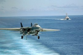 A picture downloaded from the US navy website shows a F-14 "Tomcat" from the Squadron One Zero Three (VF-103) " Jolly Rogers" preparing to land on the flight deck as USS Mahan (DDG 72) steams in the background (R) on September 30, 2009. Syria expects a military attack "at any moment", a security official told AFP on August 31, 2013 just hours after UN experts probing a suspected gas attack blamed on the regime left the country. AFP PHOTO/US NAVY/Jason R. Zalasky == RESTRICTED TO EDITORIAL USE - MANDATORY CREDIT "AFP PHOTO/US NAVY/ Rex Nelson