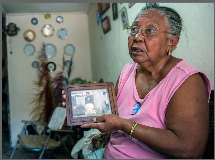 Miriam Rodriguez shows a picture of her late son Ubaldo Pino --who died of cholera last January 6-- on January 15, 2013 in Havana. The official newspaper Granma announced today a new cholera outbreak that has allegedly sickened 51 people in Havana.