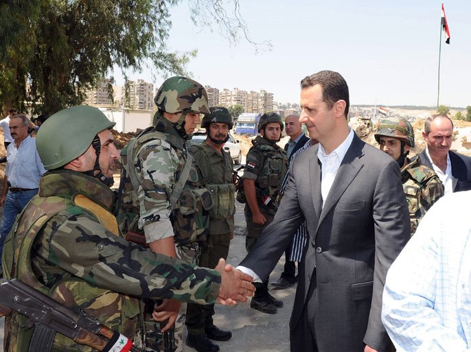 A handout picture released by the Syrian Arab News Agency (SANA) on August 1, 2013 allegedly shows Syrian President Bashar al-Assad (C) shaking hands with a Syrian army soldier in Daraya, southwestern of the capital Damascus. Al-Assad made a visit to Daraya, a former rebel bastion now mainly under government control, state television reported. In his first known visit outside the capital since March 2012, "President Assad is currently inspecting a unit of our armed forces in Daraya on the occasion of Army Day," it said without airing immediate footage with its reportA handout picture released by the Syrian Arab News Agency (SANA) on August 1, 2013 allegedly shows Syrian President Bashar al-Assad (C) shaking hands with a Syrian army soldier in Daraya, southwestern of the capital Damascus. Al-Assad made a visit to Daraya, a former rebel bastion now mainly under government control, state television reported. In his first known visit outside the capital since March 2012, "President Assad is currently inspecting a unit of our armed forces in Daraya on the occasion of Army Day," it said without airing immediate footage with its report
