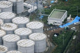 An aerial view shows workers wearing protective suits and masks working atop contaminated water storage tanks at Tokyo Electric Power Co. (TEPCO)'s tsunami-crippled Fukushima Daiichi nuclear power plant in Fukushima, in this photo taken by Kyodo August 20, 2013. Japan's nuclear watchdog said on Wednesday it is concerned that more storage tanks at the wrecked Fukushima nuclear plant will spring leaks, following the discovery that highly contaminated water is leaking from one of the hastily built containers. Picture taken August 20, 2013. Mandatory Credit.
