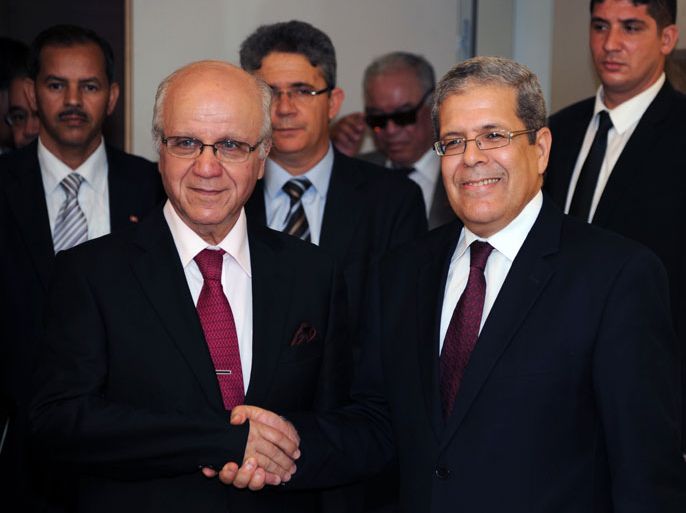 Algerian Foreign Minister Mourad Medelci shakes hands with his Tunisian counterpart Othman Jarandi (R) as they arrive for a press conference following a meeting on August 6, 2013 in Algiers. Jarandi is expected to hold talks with officials on bilateral cooperation and security issues