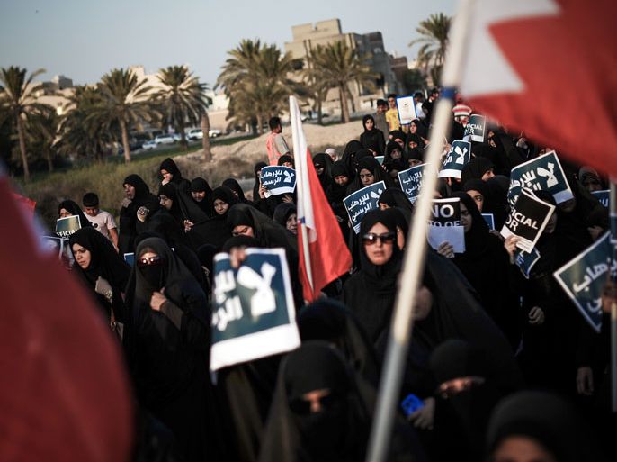 ABU SAIBA, -, BAHRAIN : Bahraini women carry posters during an anti-government rally in the village of Abu Saiba, west of Manama, on August 23, 2013. Protesters took to the streets in Bahrain demanding political reforms in the Sunni-ruled Gulf kingdom, witnesses said. AFP PHOTO/MOHAMMED AL-SHAIKH