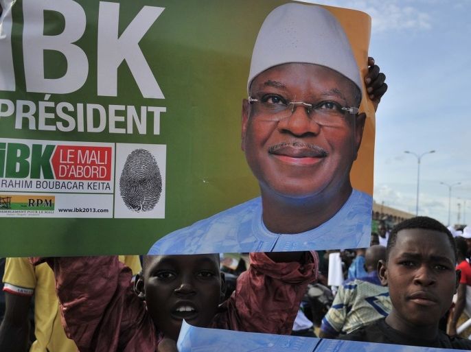 Supporters of Mali's presidential candidate Ibrahim Boubacar Keita hold a sign as they take part in a rally on August 9, 2013 in Bamako. Mali's presidential election is going to a second round on August 11 after no candidate secured a majority in the crunch poll which the runner up said was tainted by electoral fraud.