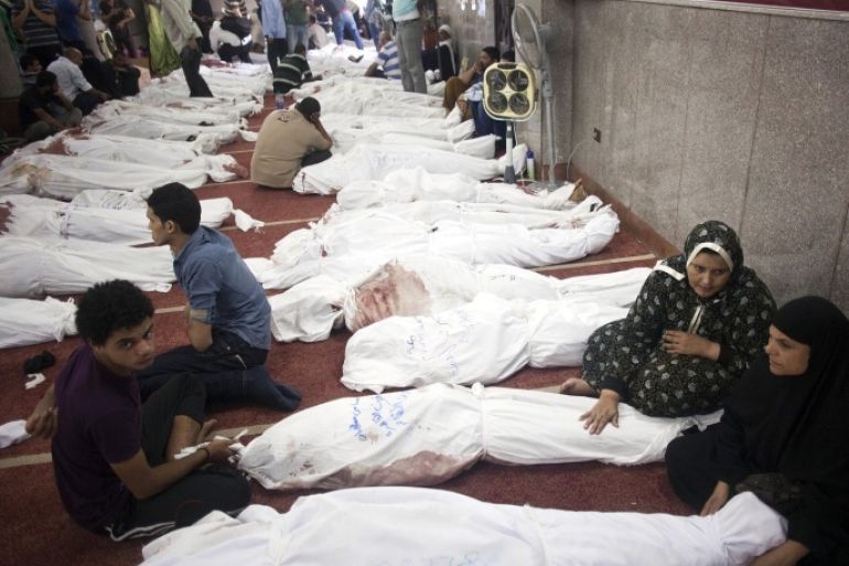 Egyptians sit next to the bodies of relatives and protesters who died following unrest the day before, at al-Imene mosque, Cairo, Egypt, 15 August 2013. At least 421 people were killed in Egypt on 14 August in violence linked to the police's break-up of two major protest camps in Cairo set up by supporters of deposed president Mohamed Morsi, the Health Ministry said. A total of 294 people were killed in Rabaa al-Adawiya in north-eastern Cairo and al-Nahda Square south of the capital during the crackdown on the campers. The rest of the deaths occurred in other areas of the country.