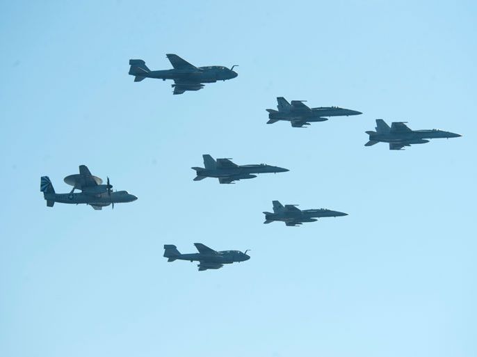 A picture released by the US Navy shows aircrafts assigned to Carrier Air Wing 7 fly in formation above the aircraft carrier USS Dwight D. Eisenhower (CVN 69) on June 15, 2013 in the Mediterranean Sea. US forces are "ready to go" if called on to strike the Syrian regime, Defense Secretary Chuck Hagel told the BBC on August 27, 2013, saying evidence pointed to its use of chemical weapons. The Pentagon chief said forces had been deployed as needed and President Barack Obama had reviewed military options presented by commanders. AFP PHOTO/US NAVY - Andrew Schneider