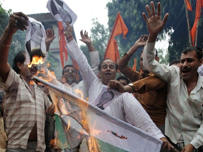 Activists of the Indian right-wing Hindu organization Shiv Sena shout anti-Pakistan slogans as they burn a Pakistani flag during a protest against the death of five Indian Army soldiers in cross-border exchanges, in Jammu on August 6, 2013. India on August 6 accused Pakistani troops of killing five of its soldiers in disputed Kashmir, only days after the two arch rivals indicated they were ready to resume peace talks.