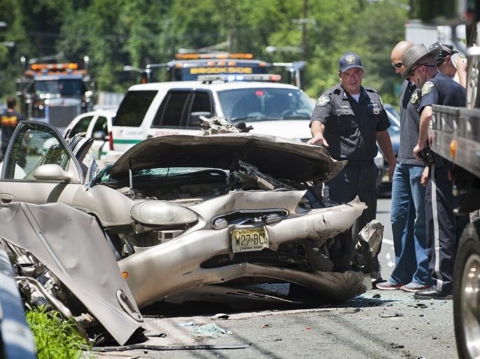 Authorities work on the scene of an accident on Rt. 4 East, just east of the Webster Ave. exit occurred when a car swerved around a police car blocking a tow truck clearing a car from an accident, Sunday July 7, 2013 in Teaneck, NJ. The car ran into the tow truck and the guard rail.