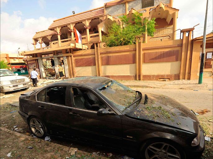 A damaged consulate car is seen outside the Egyptian consulate building following a blast in Benghazi August 17, 2013. A bomb blast ripped through the garden wall of the Egyptian consulate in the eastern Libyan city of Benghazi on Saturday, injuring a security guard who needed hospital treatment, witnesses said. REUTERS/Esam Omran Al-Fetori (LIBYA - Tags: POLITICS CIVIL UNREST)