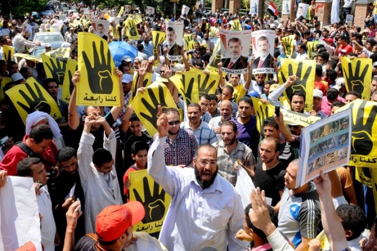 Supporters of the Muslim Brotherhood and Egypt's toppled president Mohamed Morsi (portrait) take part in a demonstration in Hilwan, south of Cairo, on August 30, 2013. Several thousand Egyptians protested in Cairo in support of ousted president Mohamed Morsi, their turnout far lower than hoped for by the harried Islamists who called for mass rallies.