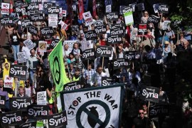 Protesters hold signs during a demonstration against military intervention in Syria in central London on August 31, 2013. British lawmakers voted late on August 29 to reject Prime Minister David Cameron's call for British involvement in military strikes aimed at punishing the Syrian regime for alleged chemical weapons use.