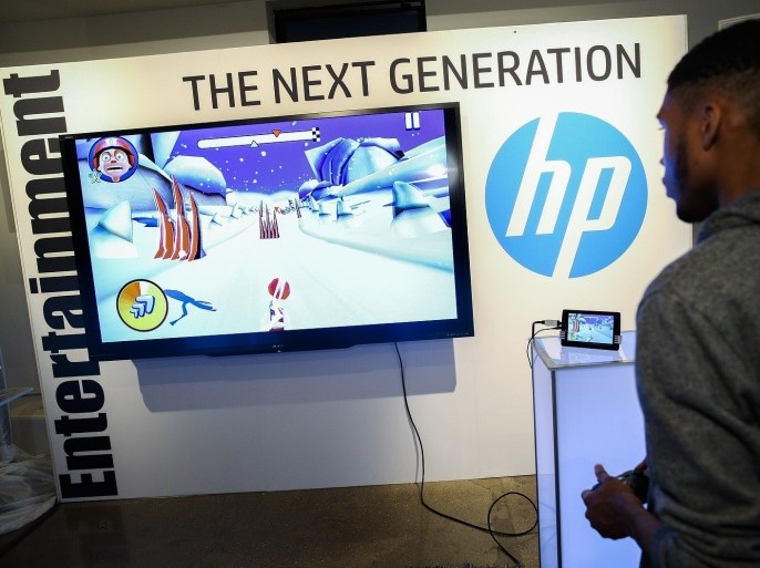 IMAGE DISTRIBUTED FOR HP - A guest plays a video game on the Slate7 Extreme tablet at the Entertainment station at the HP Next Generation PC event, Wednesday, Sept. 18, 2013, in New York.