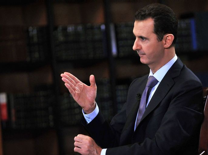 A handout picture released by the official Syrian Arab News Agency (SANA) on September 29, 2013 shows President Bashar al-Assad (R) gesturing during an interview given the day before with Italian television station Rai News 24 in Damascus. International chemical weapons experts were preparing to launch an ambitious and dangerous disarmament mission in Syria even as its relentless conflict raged on. AFP PHOTO/HO/SANA --- RESTRICTED TO EDITORIAL USE - MANDATORY CREDIT "AFP PHOTO