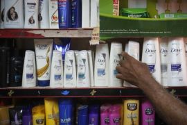 A salesman takes a bottle of Hindustan Unilever Limited (HUL) Dove shampoo from a shelf at a shop in Mumbai in this April 30, 2013 file photo. Indian companies say they can't plan more than a couple of months out as a fast-falling rupee currency drives up the cost of imports, forcing them to raise prices even as consumer spending crumbles. Makers of consumer goods like shampoos and soaps, popular defensive plays in weak economic times, are feeling the pinch, with market leader Hindustan Unilever Ltd posting lower sales volumes for a fifth consecutive quarter in the June period.