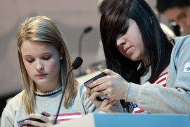Kate Moore (L) and Morgan Dynda of the U.S. compete in the LG Mobile Worldcup Texting Championship in New York in this January 14, 2010 file photo. About 37 percent of young Americans ages 12 to 17 tap the Internet using a smartphone, up sharply in just a year, according to a 2012 Pew survey released on March 13, 2013.