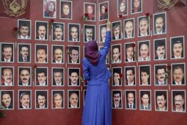 President of the National Council of Resistance of Iran (NCRI), an opposition political umbrella coalition, and leader of Mujahedeen-e-Khalq (MEK), Maryam Radjavi, places roses besides the portraits of victims as she takes part in a ceremony in homage to 52 persons killed in the Achraf refugee camp in Irak, on September 4, 2013, in Auvers-sur-Oise, outside of Paris. The Achraf refugee camp in Irak houses Iranians in exile and 52 people were killed at the camp on September 1, 2013.