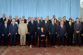 A handout picture released by Algerian Press Service (APS) news agency on September 29, 2013 shows Algerian President Abdelaziz Bouteflika (C-seated) posing for a photo with his cabinet in Algiers. Bouteflika, largely unseen for months because of health problems, presided over a cabinet he had reshuffled earlier this month, which has already approved seven draft laws, including the 2014 budget, the APS news agency reported. AFP PHOTO/HO/ALGERIAN PRESS SERVICES