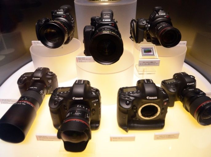Canon Cinema EOS super 35mm 4K digital cinematography camcorders, (middle L-R) C300, C500, C100 and EOS 1D C (lower 2nd R) and SLR cameras EOS 5D Mark III (bottom L), EOS 1D X (bottom 2nd L) and EOS 6D (bottom R) are displayed during the CP+ (CP plus) photo imaging show in Yokohama on January 31, 2013. Around 96 companies are participating in the exhibition with some 70,000 visitors expected in the four-day-long event.