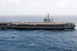 This August 29, 2013 US Navy handout image shows the aircraft carrier USS Nimitz (CVN 68) transiting the Arabian Sea. Nimitz and other ships in its strike group are heading west toward the Red Sea to help support a limited U.S. strike on Syria, if needed, defense officials said on September 1, 2013. The Nimitz carrier strike group, which includes four destroyers and a cruiser, has no specific orders to move to the eastern Mediterranean at this point, but is moving west in the Arabian Sea so it can do so if asked. AFP PHOTO / HO / US NAVY / MC3 Jess Lewis == RESTRICTE