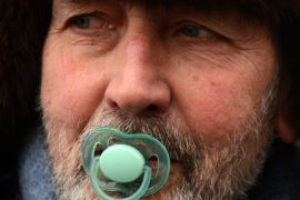 One of at least 20,000 Russian opposition supporters rallies with a pacifier in his mouth on January 13, 2013 on the Boulevard Ring in the center of Moscow against a Kremlin law that banned US adoptions of Russian orphans. The protest dubbed 'the March Against Scoundrels' was aimed at naming and shaming the lawmakers who fast-tracked the anti-adoption bill through the lower house parliament, the State Duma.
