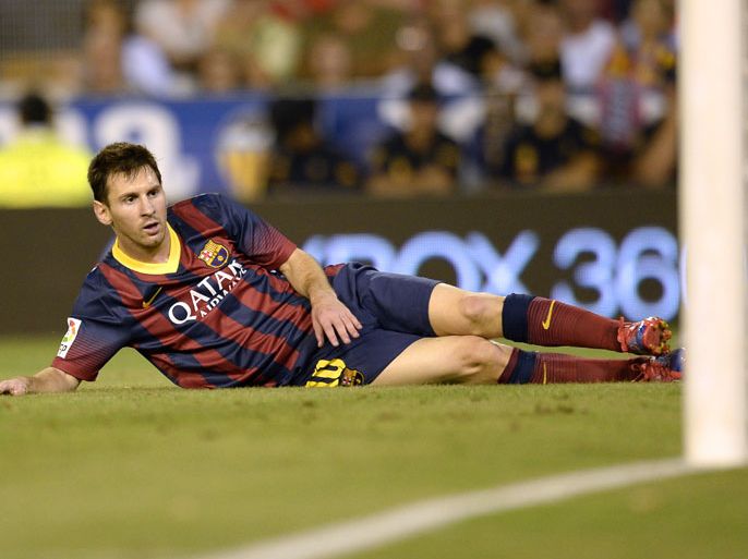 Barcelona's Argentinian forward Lionel Messi lies on the pitch during the Spanish league football match Valencia CF vs FC Barcelona at the Mestalla stadium in Valencia on September 1, 2013. AFP PHOTO/ LLUIS GENE