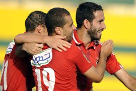 EGYPT : Egyptian Footballer Mohamed Abou Trika (C) of al-Ahly celebrates with his teammates after scoring a goal during their CAF Champions League Group A football match against Zamalek at El-Gouna stadium near Egypt's Red Sea resort of Hurghada on September 15, 2013. Al-Ahly won the match 4-2. AFP PHOTO / STR