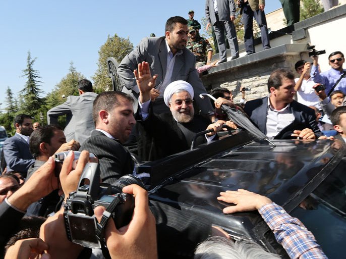 Tehran, -, IRAN : TOPSHOTS-Iranian president Hassan Rouhani waves to supporters as his motorcade leaves Tehran's Mehrabad Airport upon his arrival from New York, on September 28, 2013. Some 60 hardline Islamists chanted "Death to America" and "Death to Israel" but they were outnumbered by 200 to 300 supporters of the president who shouted: "Thank you Rouhani." AFP PHOTO/ATTA KENARE