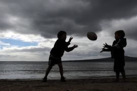 This photo taken on September 3, 2011 shows children playing rugby at Narrow Neck Beach in Devonport near Auckland less than a week before the kickoff of the 2011 Rugby World Cup. The World Cup will be played in New Zealand from September 9 to October 23.