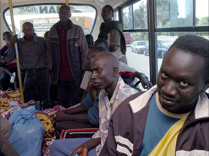 epa00549647 A group of immigrants are driven to Ouxda airport in Morocco, to be repatriated to Senegal on Monday 10 october 2005 .Hundreds of immigrants were abandoned on 07 october by Moroccan police at the Sahara desert after being arrested as the tried to climb over the fences that separate Morocco from Spanish territory of Melilla. When they were discovered by NGO Medecins Sans Frontieres, Moroccan authorities took them to a Moroccan detention center on sunday 9 october 2005 in Bouarfa, Morocco, were they were regrouped to be deported. EPA/CHEMA MOYA