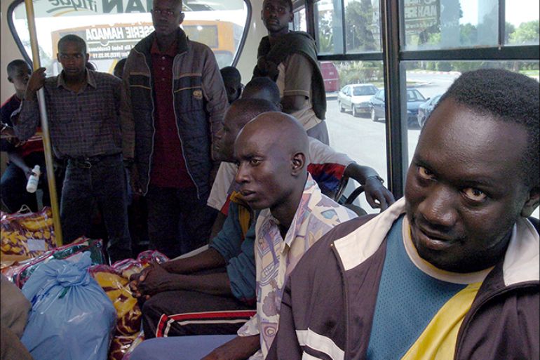 epa00549647 A group of immigrants are driven to Ouxda airport in Morocco, to be repatriated to Senegal on Monday 10 october 2005 .Hundreds of immigrants were abandoned on 07 october by Moroccan police at the Sahara desert after being arrested as the tried to climb over the fences that separate Morocco from Spanish territory of Melilla. When they were discovered by NGO Medecins Sans Frontieres, Moroccan authorities took them to a Moroccan detention center on sunday 9 october 2005 in Bouarfa, Morocco, were they were regrouped to be deported. EPA/CHEMA MOYA