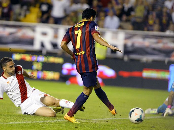 Barcelona's forward Pedro Rodriguez (C) scores a goal during the Spanish league football match Rayo Vallecano vs Barcelona at the Vallecas stadium in Madrid on September 21, 2013.