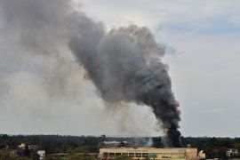 Smoke rises from the Westgate mall in Nairobi on September 23, 2013. Kenyan troops were locked in a fierce firefight with Somali militants inside an upmarket Nairobi shopping mall in a final push to end a siege that has left 43 dead and 200 wounded with an unknown number of hostages still being held. Somalia's Al Qaeda-inspired Shebab rebels said the carnage at the part Israeli-owned complex mall was in retaliation for Kenya's military intervention in Somalia, where African Union troops are battling the Islamists. AFP PHOTO / CARL DE SOUZA