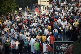 Bahraini protesters wave their national flags as they take part in an anti-government protest in the village of Jannusan, west of the capital Manama, on September 27, 2013. Thousands took to the streets in Bahrain to condemn the arrest of ex-MP Marzooq, hours after clashes between protesters and police, officials and witnesses said. AFP PHOTO