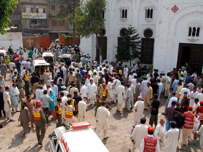People gather at a Christian Chruch after twin suicide bombings, in Peshawar, the provincial capital of militancy-hit Khyber-Pakhtunkhwa province, Pakistan, 22 September 2013. At least 60 people were killed and more than 100 injured when two suicide bombers detonated explosives strapped to their bodies during a Sunday Mass at a Church in Peshawar. EPA/ARSHAD ARBAB