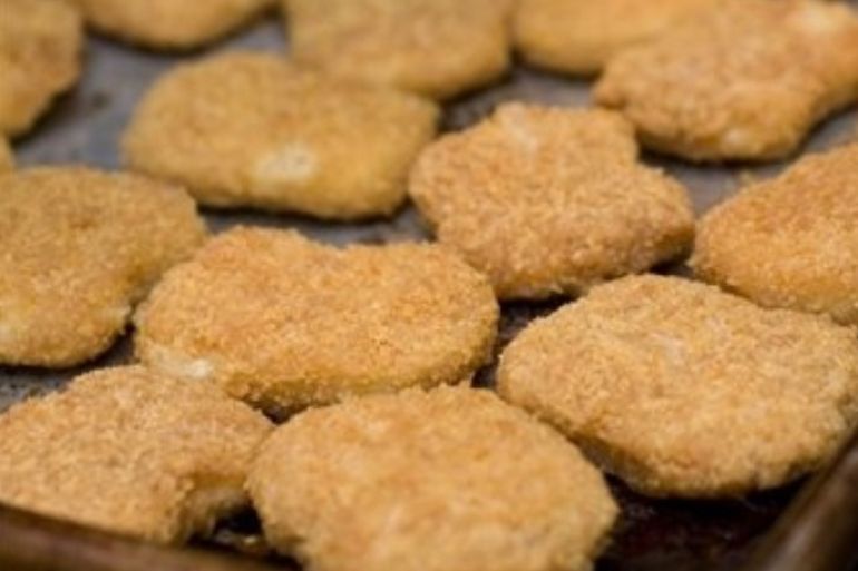 Chicken nuggets, fresh from the oven, are seen in this May 2, 2010 photo. Kids love chicken nuggets, but Consumer Reports says watch out for fat and salt.
